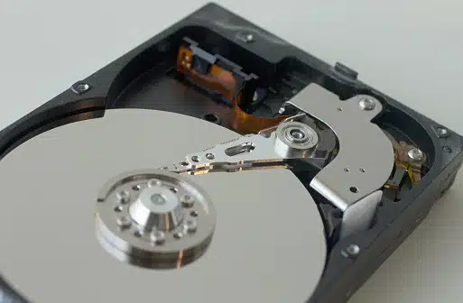 Technician recovering data from an IDE internal hard disk head at Payam Data Recovery, Australia.
