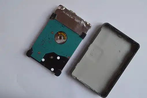 Technician recovering data from an open external hard disk at Payam Data Recovery, Australia.
