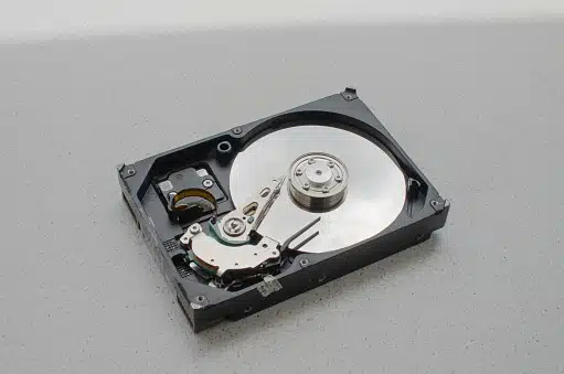 Technician recovering data from an HDD revealing internal components at Payam Data Recovery, Australia.