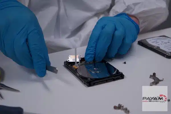 Technicians performing Seagate hard drive data recovery in a Sydney cleanroom during a head swap operation.