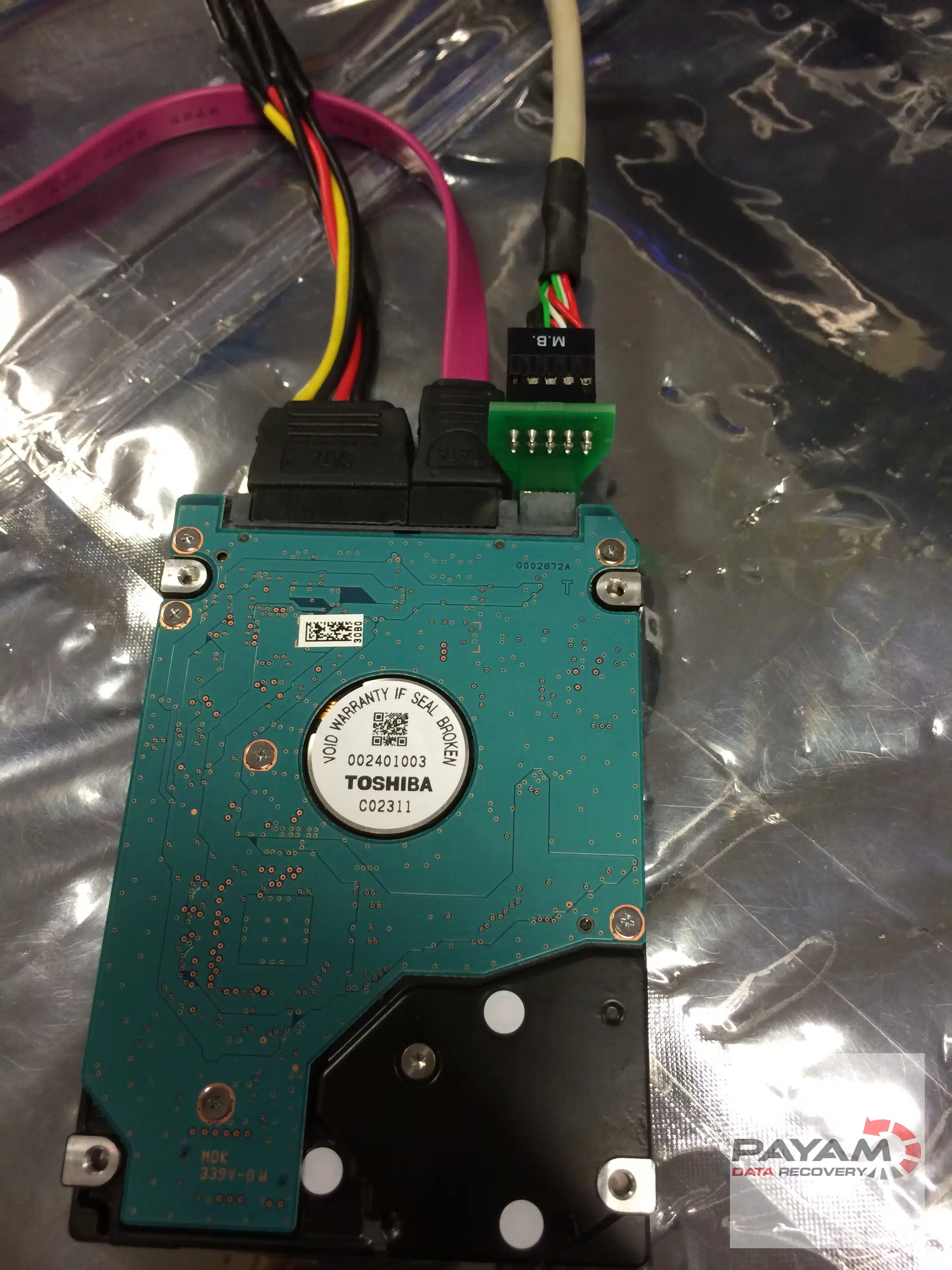 Payam Data Recovery technician connects 2.5-inch HDD with SATA cable for hard drive data recovery in Sydney.
