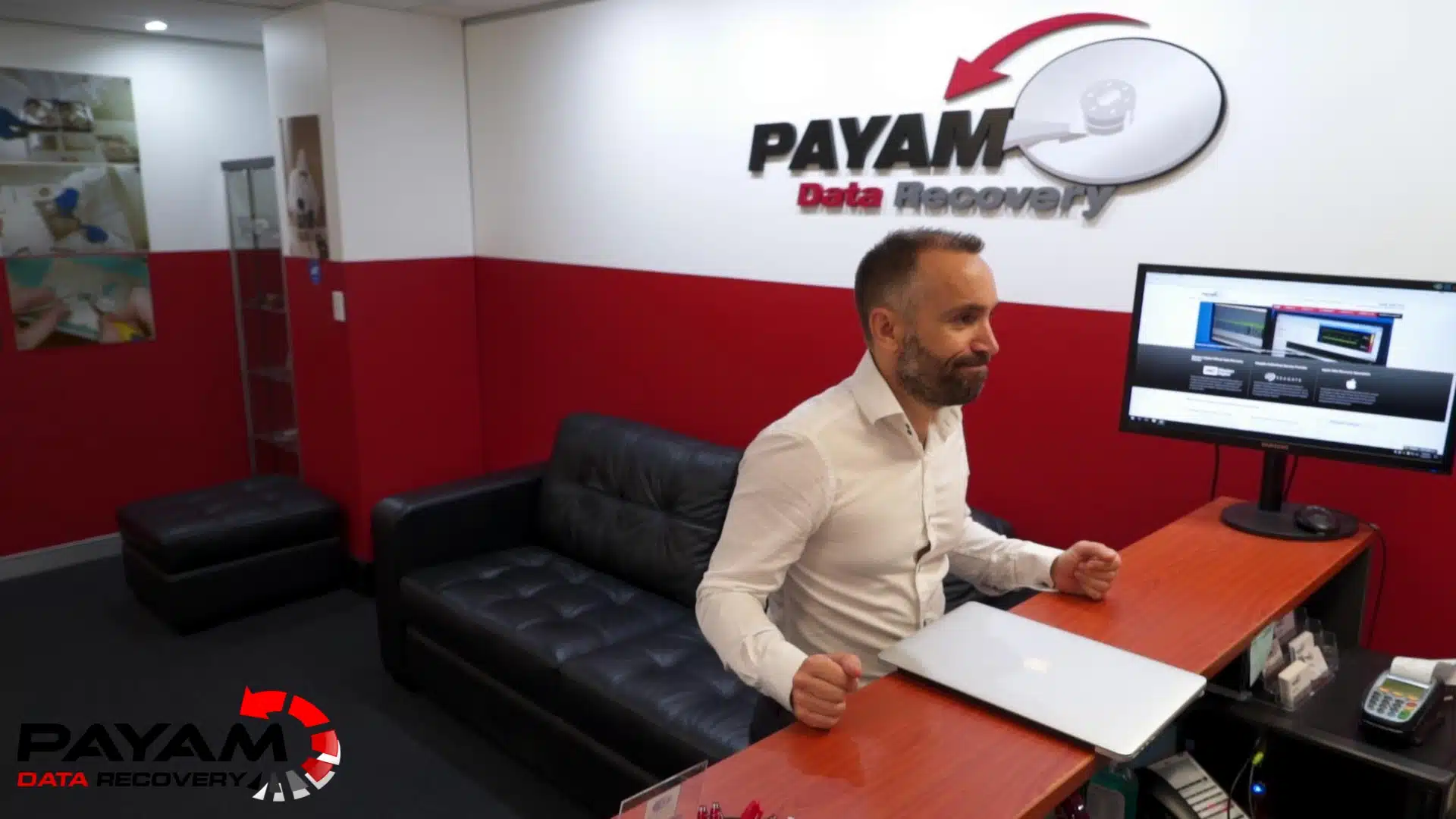 Payam Data Recovery staff returning a MacBook to a customer in Perth