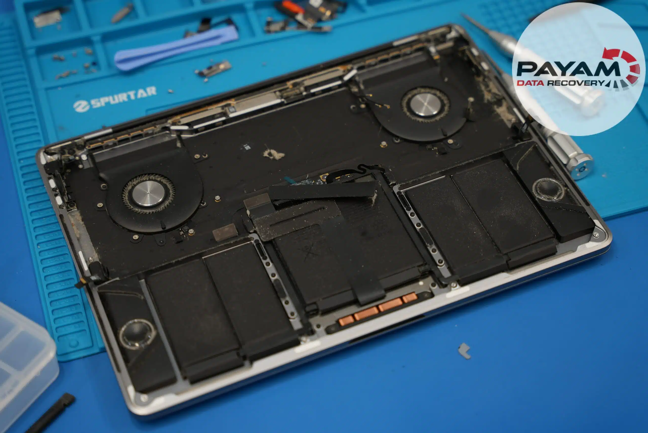 MacBook with back cover removed showing logic board
