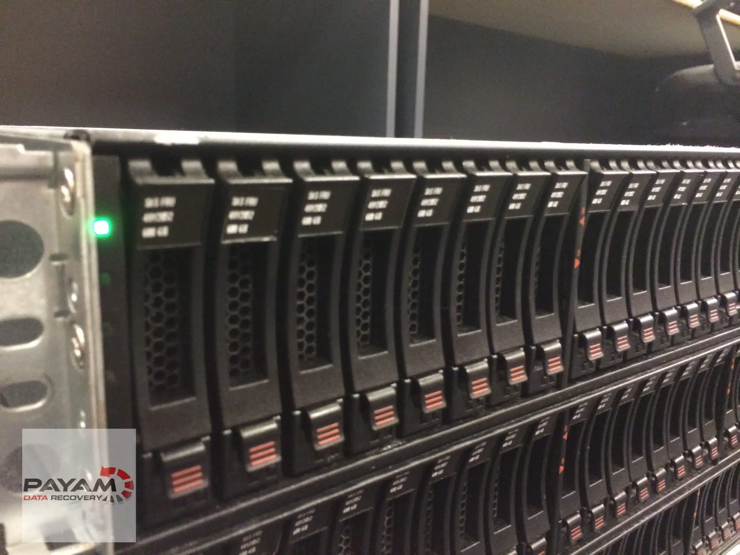Server rack with a long row of hard drive bays in the server room