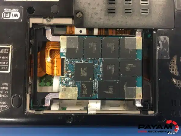 Corrupt SSD data recovery Perth specialist examining Toshiba 2.5-inch SSD at Payam Data Recovery Melbourne