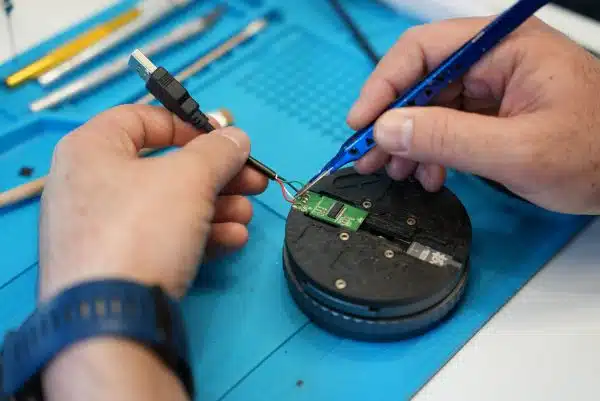 Bent USB drive data recovery case study: unbranded USB flash drive with broken connector pin, manually traced copper tracks repaired by microsoldering at Payam Data Recovery's Rhodes lab in New South Wales