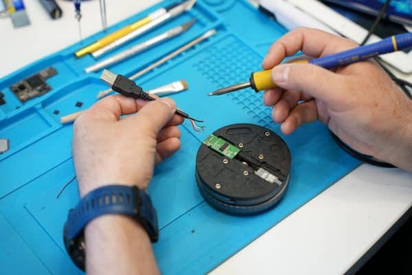 USB connector repair Perth case study: technician expertly soldering USB flash drive connector to recover lost data
