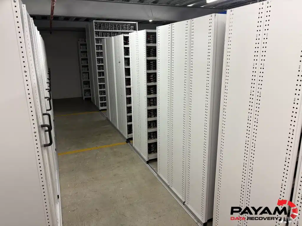 Rows of shelving holding donor hard drives in the spare parts room