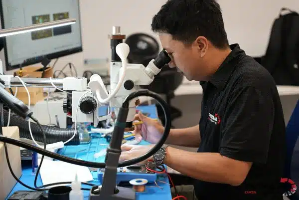 Technician working at a microscope station in the lab