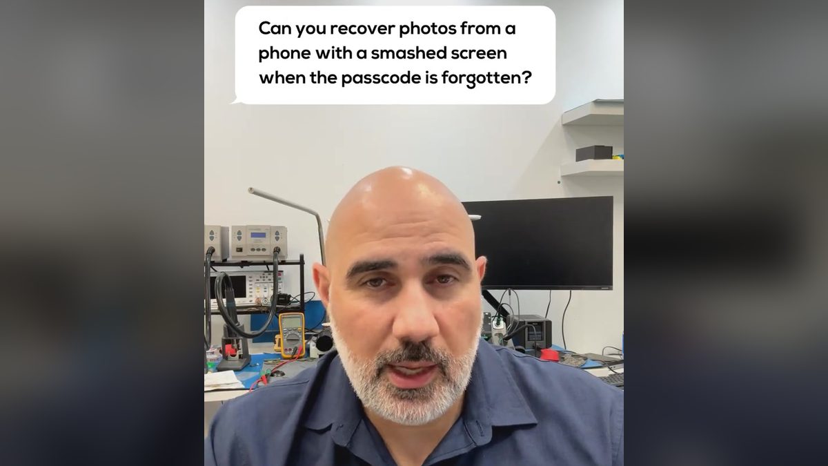 Video still: presenter at a lab bench with an on screen question about a phone with a smashed screen and forgotten passcode