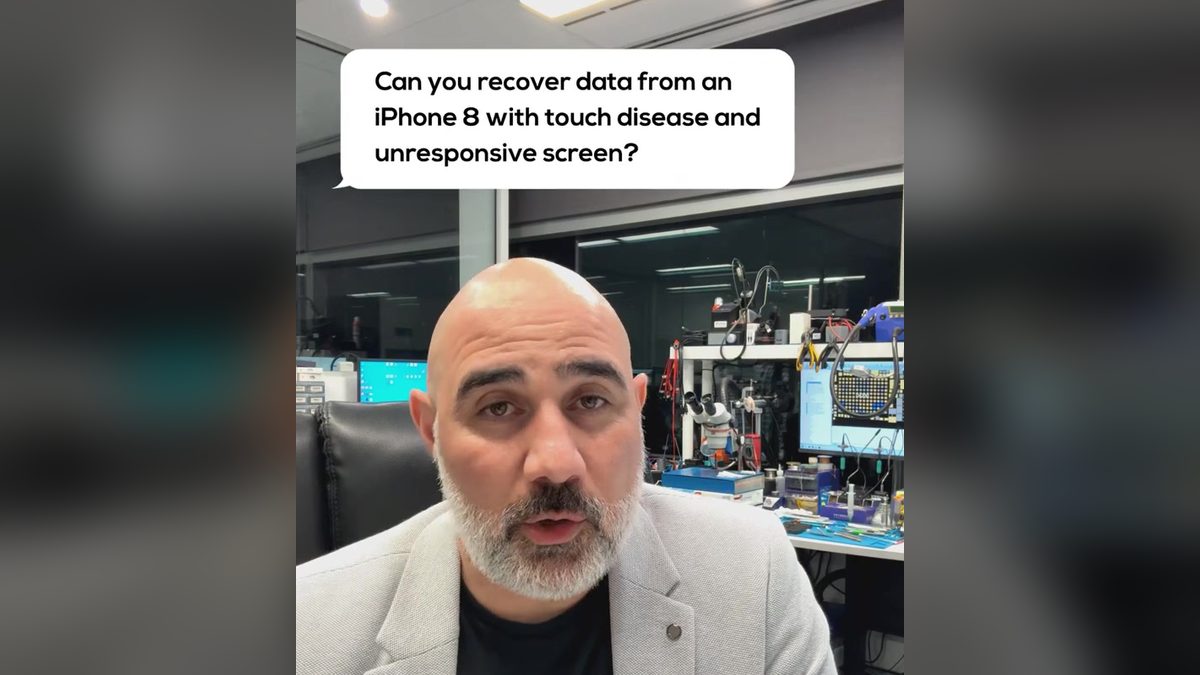 Video still: presenter in the lab with an on screen question about an iPhone 8 with touch disease